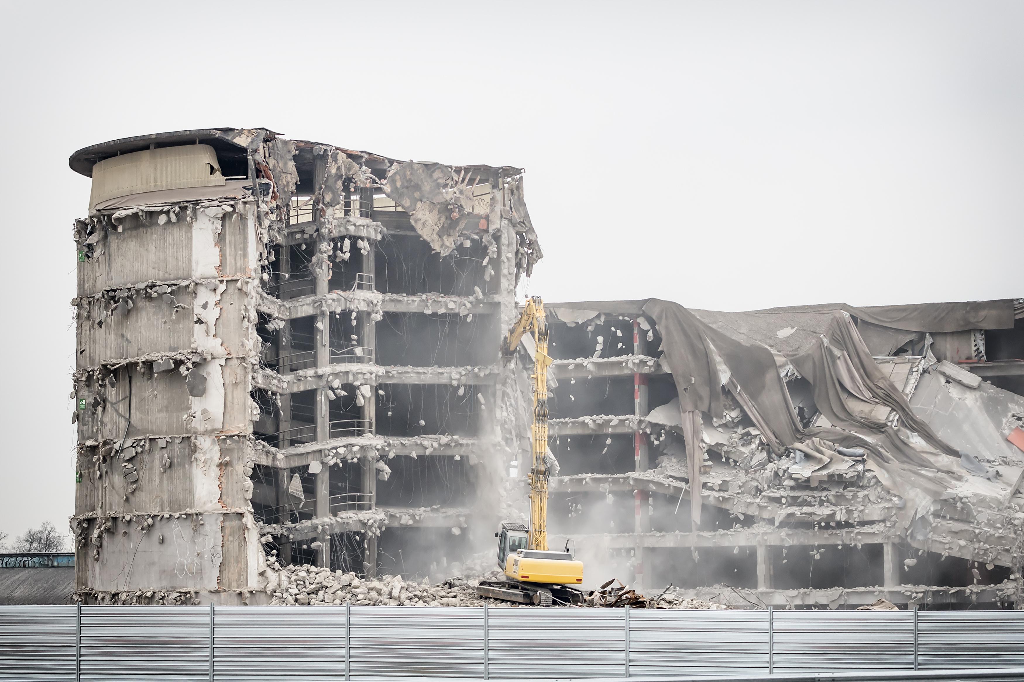 Demolition Services Brisbane Commercial building being demolished by an excavator